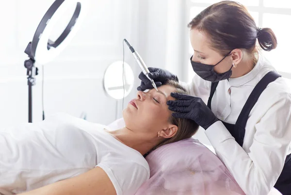 Microblading eyebrows work flow in a beauty salon.