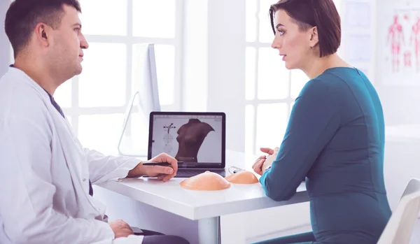 Doctor showing young patient her chest xray in his office at the hospital — Stock Photo, Image