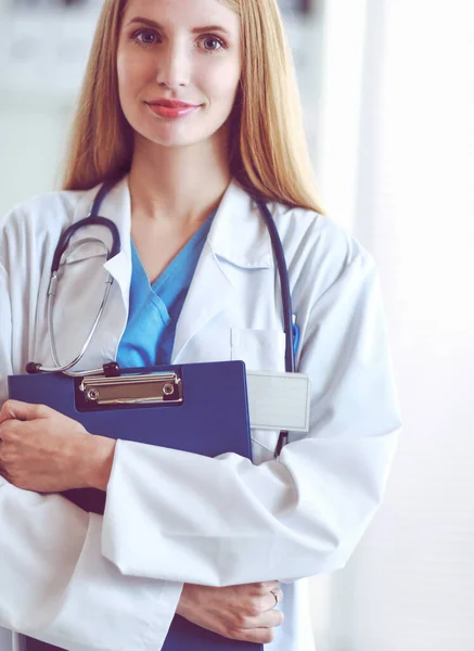 Portrait of woman doctor with folder at hospital corridor — Stock Photo, Image
