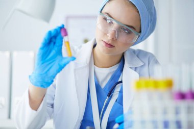 Laboratuvar asistanı bir kan örneğini analiz ediyor.