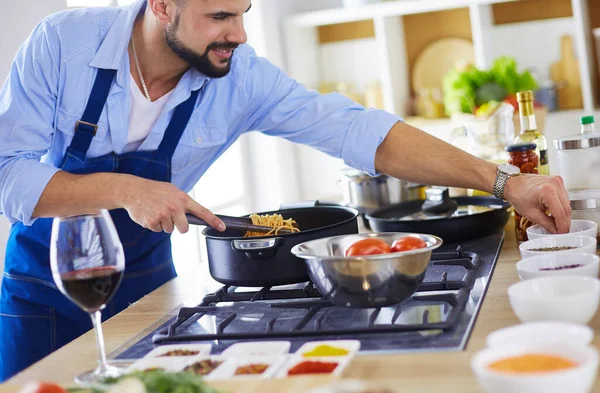 Man preparing delicious and healthy food in the home kitchen