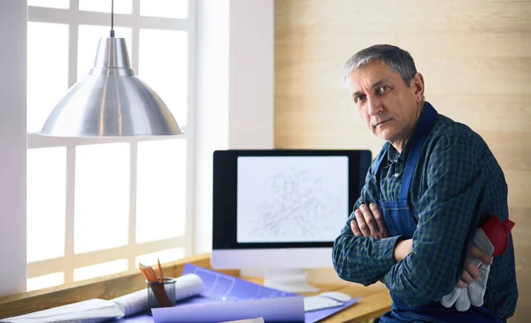 Architect working on drawing table in office