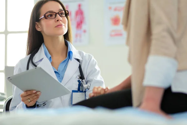 Dokter en patiënt bespreken iets terwijl ze aan tafel zitten. Begrip "geneeskunde en gezondheidszorg" — Stockfoto