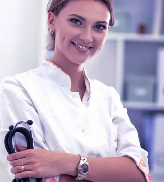 Young woman doctor standing at hospital with medical stethoscope — Stock Photo, Image