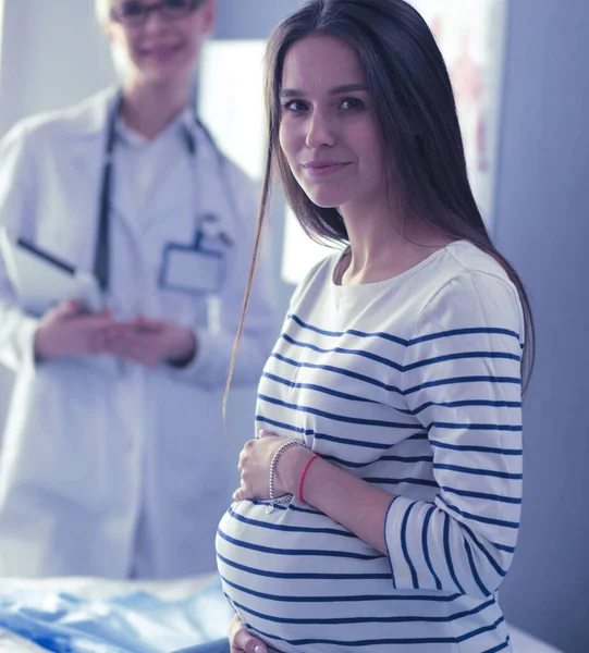 Beautiful smiling pregnant woman with the doctor at hospital Royalty Free Stock Images