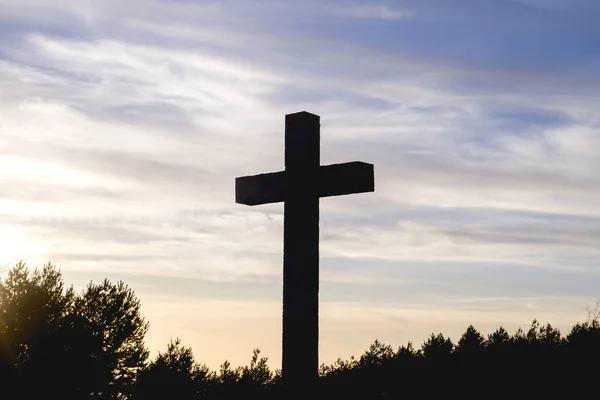 Christian cross at sunset