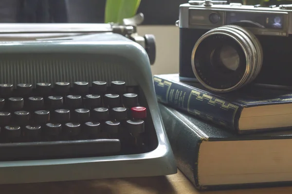 old vintage typewriter with camera and books