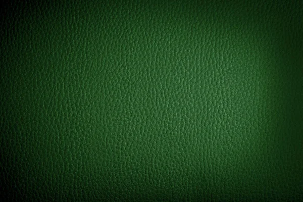 dark green leather background or texture with dark vignette bord