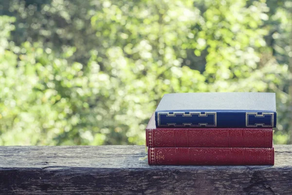 Old books on the garden wooden table