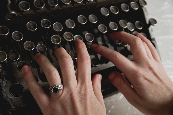 woman hands writing with an antique typewriter