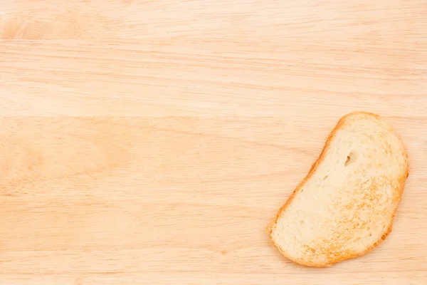 Ένα Κομμάτι Ψωμί Μπεζ Ξύλινο Φόντο Για Σχεδιασμό Της Σελίδας — Φωτογραφία Αρχείου