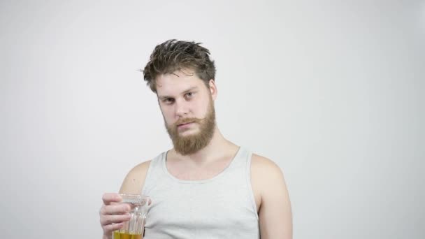 Drunk bearded guy drinking light beer and kicks the taste — Stock Video