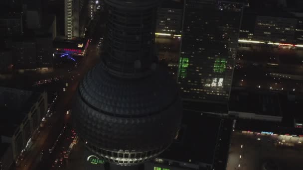 AERIAL: Close Up of Berlin Germany TV Tower Alexanderplatz at Night with City Lights traffic — Stock Video