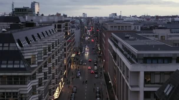 AERIAL: Low View into Berlin Mitte Friedrichstrasse and Car Traffic City Lights, Subway Train Stations on Cloudy Day before Sunset — Stock Video