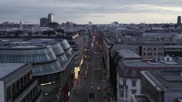 AERIAL: Low View into Berlin Mitte Friedrichstrasse and Car Traffic City Lights, Subway Train Stations on Cloudy Day before Sunset — стокове відео