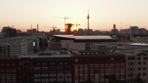 AERIAL: Let nad Berlínem, Německo při krásném západu slunce, Sluneční světlo a pohled na Alexanderplatz TV Tower a Ostbahnhof, Sunflairs — Stock video