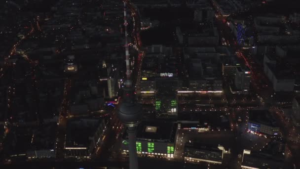 AERIAL: Over Berlin Germany TV Tower Alexanderplatz at Night with City Lights traffic — Stock Video