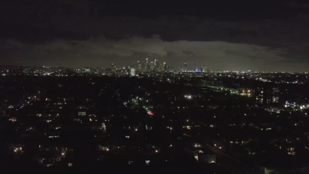 AERIAL: Over Dark Hollywood Los Angeles at Night with Clouds over Downtown and City Lights — Stock video