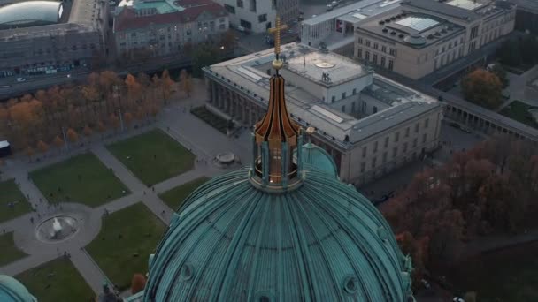 AERIAL: Circling Berlin Cathedral Top with golden cross and streets in background, Germany in Fall colors at beautiful Sunset — Stock Video