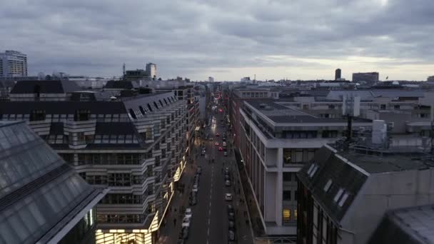 AERIAL: Low View into Berlin Mitte Friedrichstrasse and Car Traffic City Lights, Subway Train Stations on Cloudy Day before Sunset — стокове відео