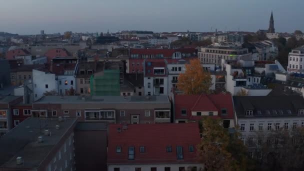 AERIAL: Sobre los coloridos roodftops de Berlín, Alemania en colores otoñales Rojo, naranja y amarillo al atardecer — Vídeos de Stock