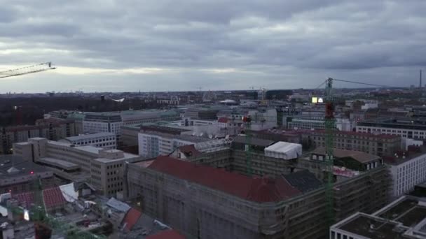 AERIAL: Slowly flying over Center of Berlin Germany with Construction Site Cranes at Sunset — Stock Video