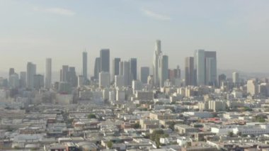 Los Angeles şehir merkezine doğru nefes kesen geniş bir çekim, güzel güneş ışığı altında California Skyline, mavi gökyüzü, 