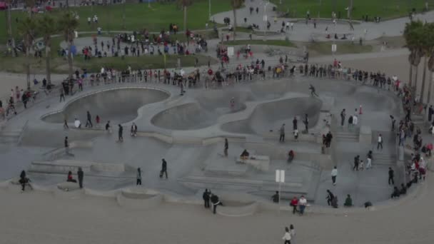 AERIAL: Close Up of Venice Beach Skatepark with Visitors and Skaters, Skating, Sunset, Los Angeles, California — стокове відео