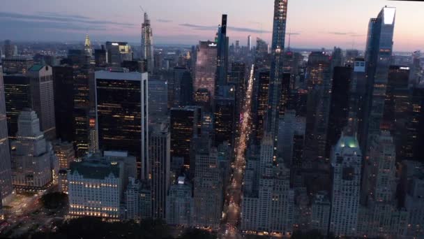 AERIAL: Manhattan Skyline at night with flashing City lights in New York City over Central Park — Stock Video