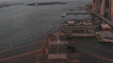 Brooklyn Köprüsü üzerinde Amerikan bayrağı ve sisli Manhattan New York City Skyline 'ı ile daire uçuşu yakın. 
