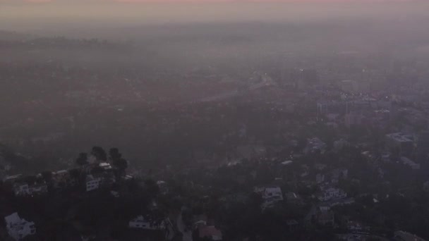 AERIAL: Over Hollywood Hills at Sunrise, with view on Los Angeles in cloud — 비디오