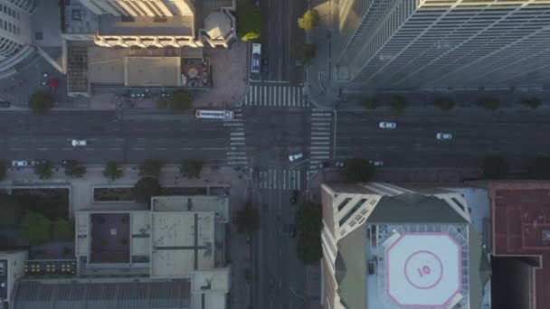 AERIAL: Slow Birds eye View flight over Downtown Los Angeles California in beautiful Sunrise Light with view of skyscraper hustak och biltrafik passerar — Stockvideo