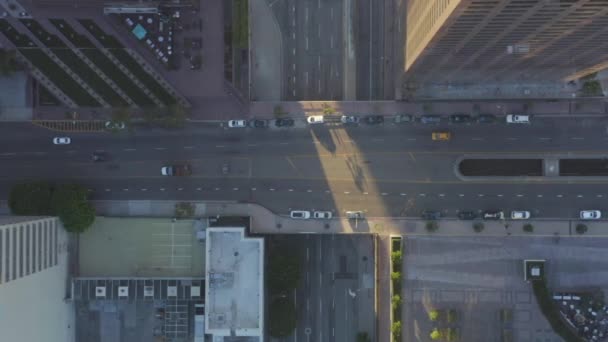 AERIAL: Slow Birds eye View flight on Downtown Los Angeles California Grand Avenue in beautiful Sunrise Light with car traffic passing — стоковое видео