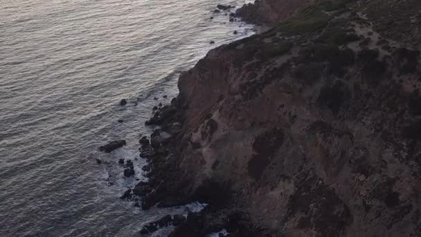 AERIAL: flyg över Malibu, Kalifornien utsikt över stranden Shore Line Paficic ocean at sunset with mountain cliff — Stockvideo