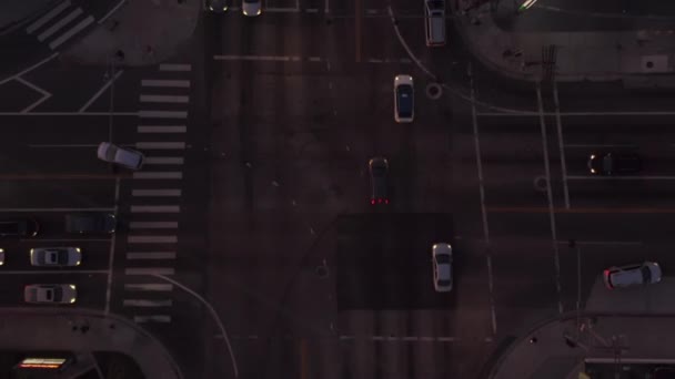 AERIAL: Birds eye view of Culver City, Los Angeles, California traffic, interesction at dusk with car traffic passing and parking lot — Stock Video