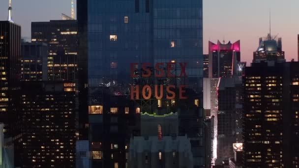 AERIAL: close up of Essex House Manhattan Skyline at night with flashing City lights in New York City at Central Park — 图库视频影像