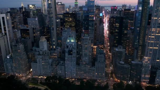 AERIAL: Manhattan Skyline at night with flashing City lights in New York City at Central Park — Stock Video