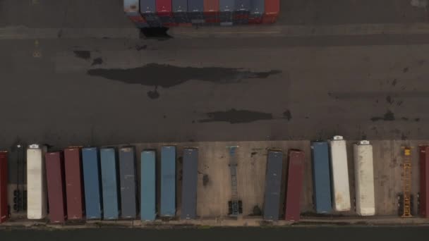 AERIAL: Birdseye Vista de contêineres de carga industrial vermelho e azul em — Vídeo de Stock