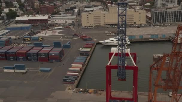 AERIAL: High angled view of industrial cranes in docks in New York City on cloudy day — Stock Video