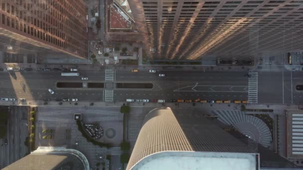 AERIAL: Slow Birds eye View flight on Downtown Los Angeles California Grand Avenue in beautiful Sunrise Light with car traffic passing — стоковое видео