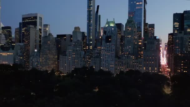 AERIAL: Manhattan Skyline at night with flashing City lights in New York City at Central Park — Stock Video