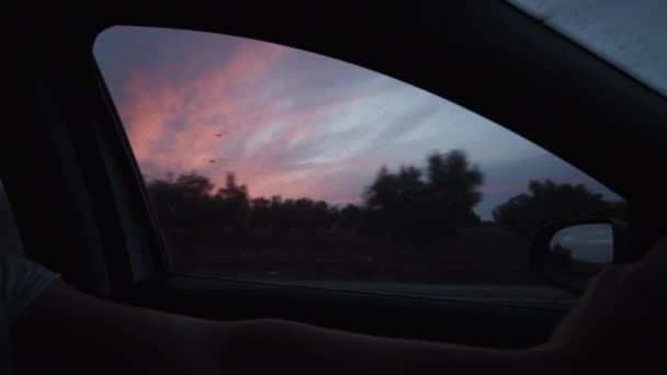 SLOW MOTION: BEAUTIFUL FIRE RED SKY AT DUSK OUT OF MOVING CAR ON HIGHWAY — Stock Video