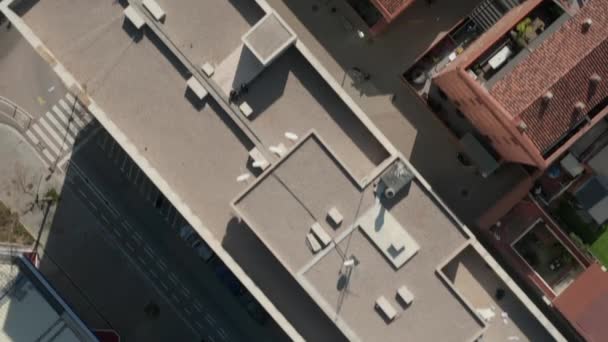 AERIAL: Беспилотник рядом с Барселоной, Испания Крыши в солнечном свете с движением на улицах — стоковое видео