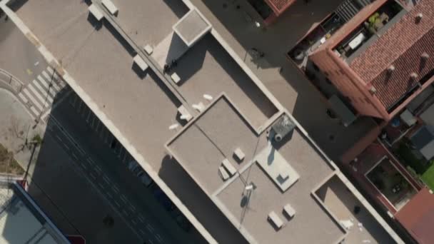 AERIAL: Close Overhead Drone shot of Barcelona, Spain Rooftops in Sunlight with Traffic on street — 비디오