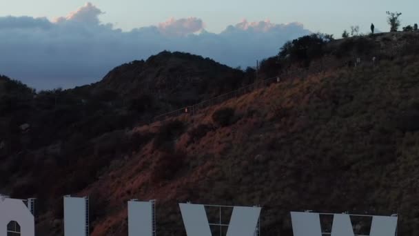 AERIAL: Flight over Hollywood Sign, Hollywood Hills with view on Valley, Burbank with Beautiful Sunset and Clouds — стокове відео