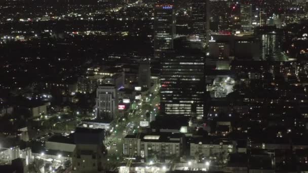 AERIAL: Over Dark Hollywood Los Angeles at Night with view on Skyline and City Lights — Stock Video