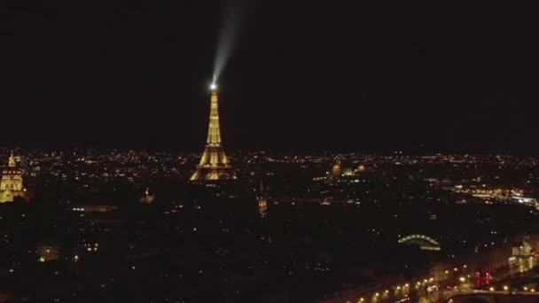 AERIAL: View over Seine River at Night in Paris, France with View on Eiffel Tower, Tour Eiffel Shining light and Beautiful City Lights — стоковое видео