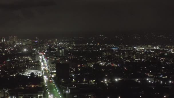 AERIAL: Over Dark Hollywood Los Angeles - Night view on Wilshire Blvd with Clouds over Downtown and City Lights — 비디오