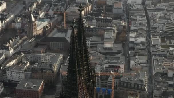 AEREO: Primo piano che gira intorno alla Cattedrale di Colonia in una bellissima luce del sole nebbiosa con pioggia — Video Stock