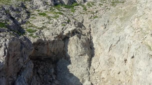 AERIAL: Man die op de rand van de klif staat met blauwe watergolven die verpletteren op Tropisch eiland Mallorca, Spanje Vakantie, Reizen, Zonnig, Golven — Stockvideo